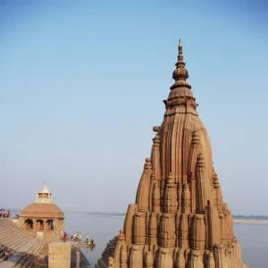 Partially submerged tilted Shiva temple below the ghats