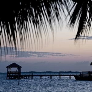 People in beach bar near the Moorings at sunset, Placencia, Belize, Central America