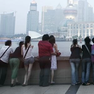 People on the Bund looking over to the Oriental Pearl Tower and the Pudong District