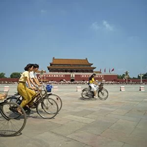People cycling through Tiananmen Square outside the Forbidden City, Beijing, China, Asia