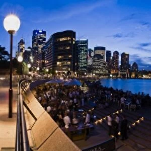 People drinking in the opera house bar at dusk, Sydney Opera House, Harbour Bridge and skyline, Sydney, New South Wales, Australia, Pacific