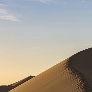 People in silhouette on Khongor sand dunes in Gobi Gurvan Saikhan National Park, Sevrei district