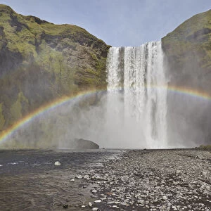 A permanent rainbow in waterfall spray, Skogafoss Falls, near Vik, southern Iceland