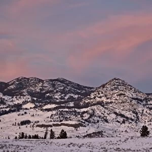 Pink clouds over snow-covered hills at sunset, Yellowstone National Park, UNESCO