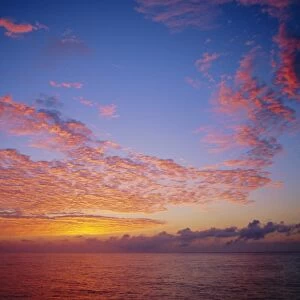 Pink and orange clouds at sunrise over the English Channel, England, UK
