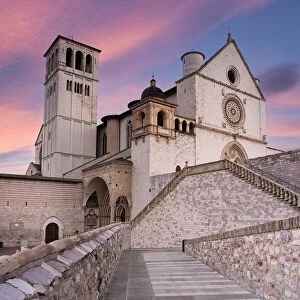 Pink sunrise over the Papal Basilica of Saint Francis in Assisi
