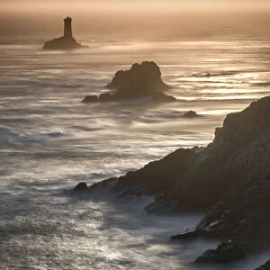 Pointe du Raz lighthouse and cliffs at sunset in Finisterre, Brittany, France, Europe