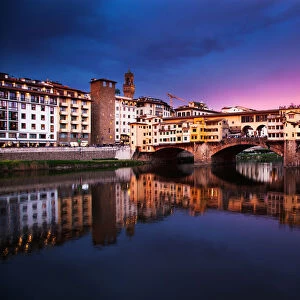 Ponte Vecchio at sunset reflecting in River Arno, Florence, UNESCO World Heritage Site