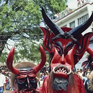Portrait of two people with devil masks