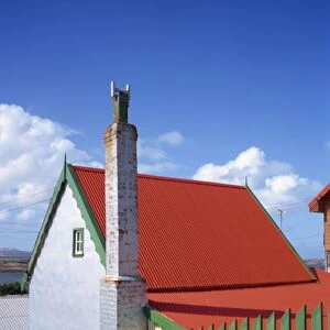 A private house with red corrugated roof and green fence in Stanley, capital of the Falkland Islands