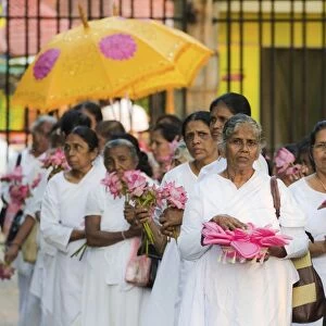 Procession of female Buddhist devotees with offerings at the sacred Temple of the Sacred Tooth Relic, Kandy, Sri