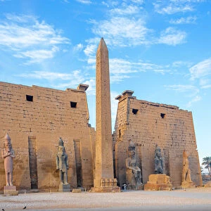 The Pylon of Ramesses ll with the Eastern Obelisk and the Two Colossi of the King seated on his Throne, Luxor Temple, Luxor, Thebes, UNESCO World Heritage Site, Egypt, North Africa, Africa