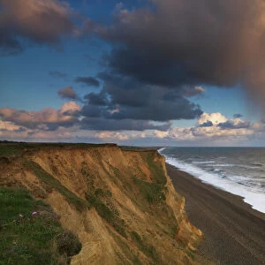 A rain cloud approaches the cliffs at Weybourne, Norfolk, England