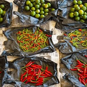Red chilli peppers and limes, food market, Kuching, Sarawak, Malaysian Borneo, Malaysia, Southeast Asia, Asia