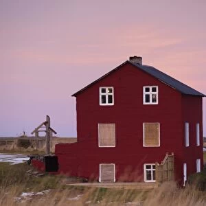 Red house at sunset at Bakkagerdi, village in Borgarfjordur Eystri fjord