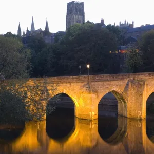 The River Wear and Elvet Bridge illuminated by night, the cathedral on hillside beyond