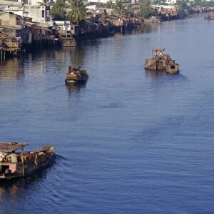 Riverside homes and boats on the Saigon River