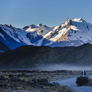 Road in Mount Cook National Park with illuminated mountains in the background, UNESCO World Heritage Site, South Island, New Zealand, Pacific