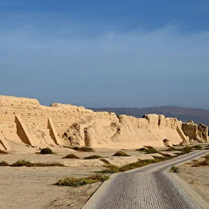 Road past ruined city wall of ancient Silk Road city of Gaochang, Taklamakan desert