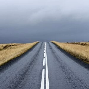 Road stretching away towards stormy sky, Snaefellsnes Peninsula, Iceland, Polar Regions