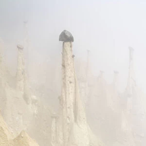 Rock pinnacles of the Earth Pyramids emerging from fog, Perca (Percha)