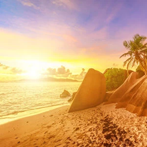 Rocks on beach and palm trees, Anse Source d Argent at sunset, La Digue, Seychelles