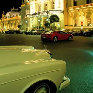 Rolls Royce and Ferrari parked in front of the Casino at night, Monte Carlo