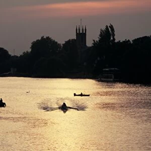 Rowers on River Thames with church tower beyond, Hampton, Greater London