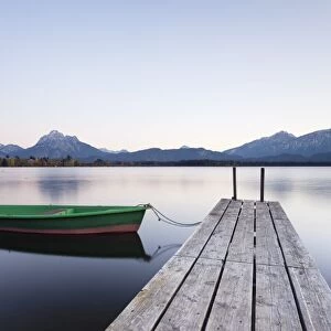 Rowing boat on Hopfensee Lake at sunset, near Fussen, Allgau, Allgau Alps, Bavaria, Germany, Europe
