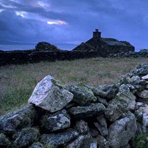 Ruined crofthouse and lowering sky