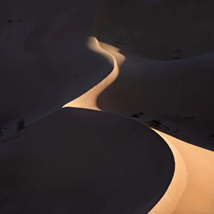 Sand dunes at sunrise with high contrast in the Rub al Khali desert, Oman, Middle East