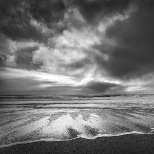 Sea stacks, tall cliffs and black basalt sandy beach at Vic on the southern coast