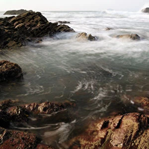 Sea swirling around rocks, near Polzeath, Cornwall, England, United Kingdom, Europe