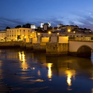 Seven arched Roman bridge and town on the Rio Gilao river at night, Tavira, Algarve