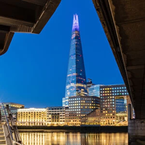 The Shard and London Bridge at sunrise with reflections on the River Thames, London