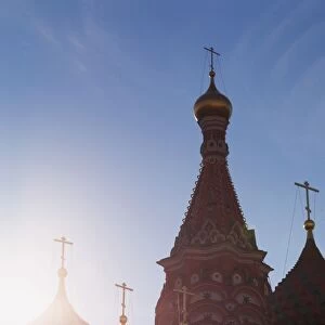 Silhouette of the onion domes of St. Basils Cathedral in Red Square, UNESCO World Heritage Site, Moscow, Russia, Europe pushed red in shadows using curves