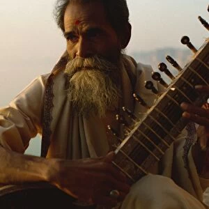 Sitar and player beside the Ganga River, Varanasi, Uttar Pradesh state, India, Asia