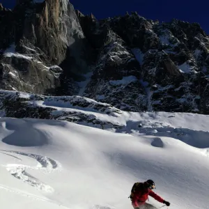 A skier enjoying perfect powder snow on the celebrated Pas de Chevre off-piste run