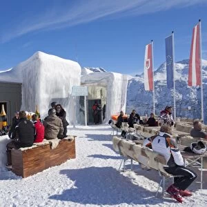 Skiers enjoying drinks at the Icebar Lech near St. Anton am Arlberg in winter snow