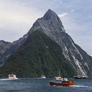 Small boats in the water of Milford Sound in front of Mitre Peak