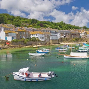 Small fishing boats in the enclosed harbour at Mousehole, Cornwall, England