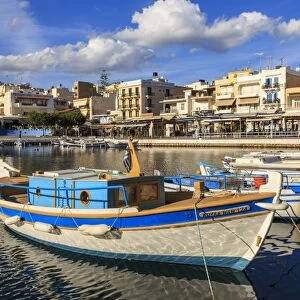 Small fishing boats reflected in Voulismeni Lake, Agios Nikolaos, Lasithi, Crete