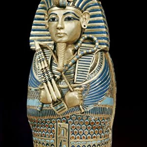 One of the four small gold mummiform coffins placed in the canopic urns