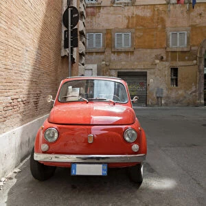 Small old Fiat 500 car parked on a back street in Rome, Lazio, Italy, Europe