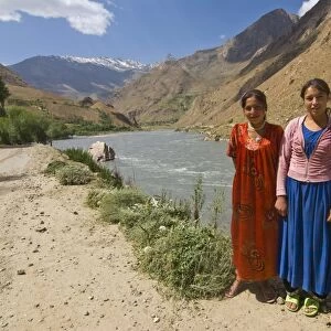 Smiling women posing by river, Wakhan Valley, The Pamirs, Tajikistan, Central Asia, Asia