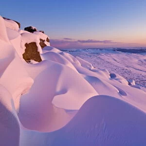 Snow covered moorland at sunset on Stanage Edge, Peak District National Park