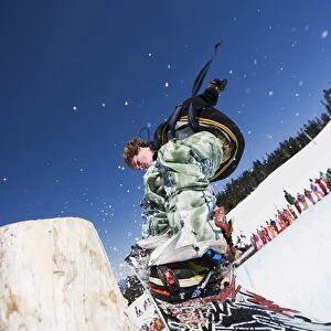 A snowboarder jumping at Telus Half Pipe competition 2009, Whistler mountain