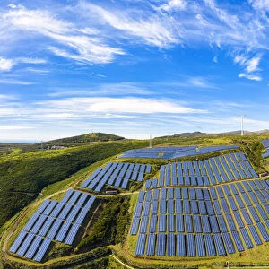 Solar panels and wind turbines on the green plateau, Encumeada, Madeira island, Portugal