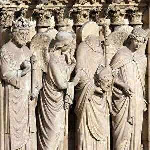 Detail of St. Denis holding his head flanked by two angels, Virgin portal, Western facade