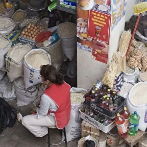 Stalls selling eggs, rice, flour, pulses, pumpkin seeds and other dried goods in the modern 10th de Agosto market on Calle Larga, Cuenca, Azuay Province, Southern Highlands, Ecuador